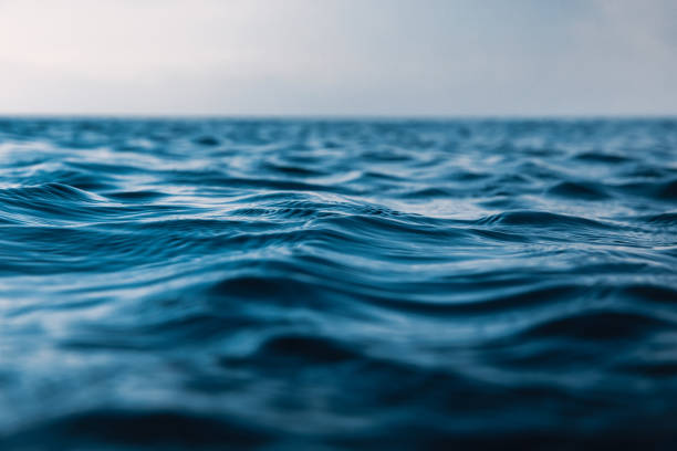 istock Blue waves in ocean. Water texture with bokeh 1202060135
