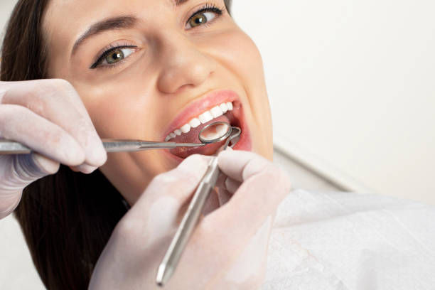 istock Young pretty lady making treatment in dental clinic 1202060194