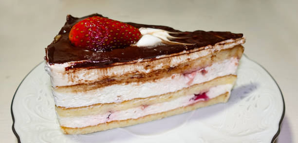 istock One piece of chocolate cake with strawberries on a white plate 1202060279