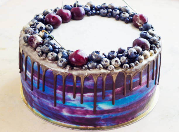 istock Bright festive blue cake with berries and chocolate. modern cake 1202061965
