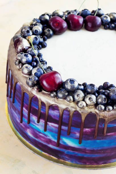 istock Bright festive blue cake with berries and chocolate. modern cake 1202062002
