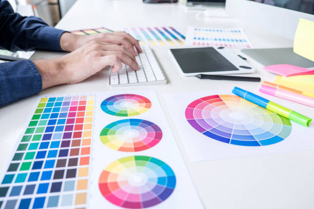 istock Image of male creative graphic designer working on color selection and drawing on graphics tablet at workplace with work tools and accessories 1202063009