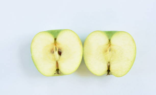 istock green apple healthy fruit half cut on white background 1202064798