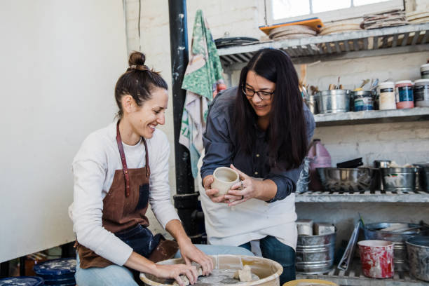 istock An art teacher giving instruction, help and tips to a student 1202066012