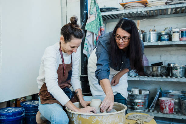 istock An art teacher giving instruction, help and tips to a student 1202066015