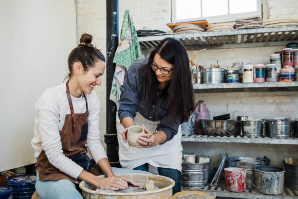 istock An art teacher giving instruction, help and tips to a student 1202066081