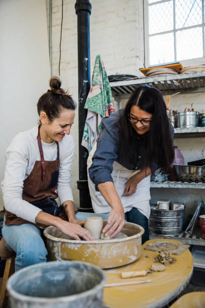 istock An art teacher giving instruction, help and tips to a student 1202066339