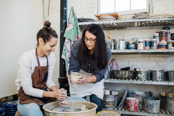 istock An art teacher giving instruction, help and tips to a student 1202066452