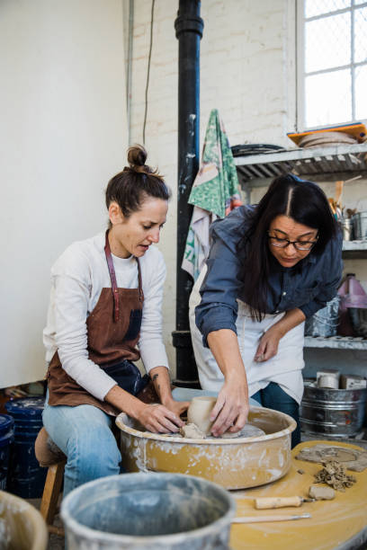 istock An art teacher giving instruction, help and tips to a student 1202066533