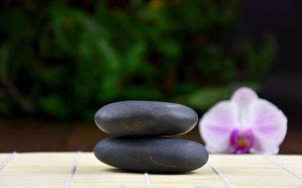 istock Massage stones with orchid stock images 1202066664