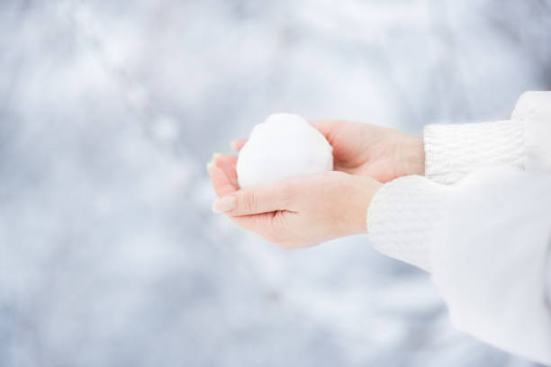 istock Woman playing with snowball 1202069999