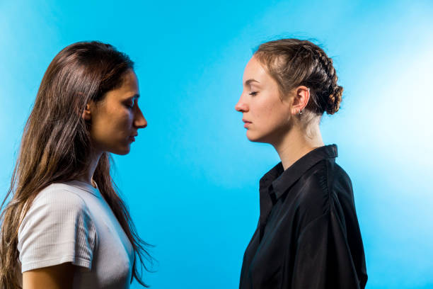 istock Profile of Two Women Facing Each Other With Eyes Closed 1202070092