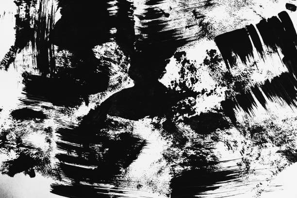 istock Patterns of black paint from a brush on a white background 1202071472