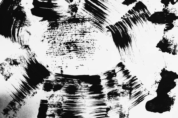 istock Patterns of black paint from a brush on a white background 1202071572