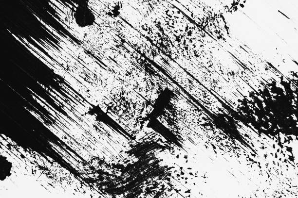 istock Patterns of black paint from a brush on a white background 1202071644