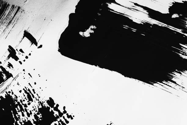 istock Patterns of black paint from a brush on a white background 1202071683