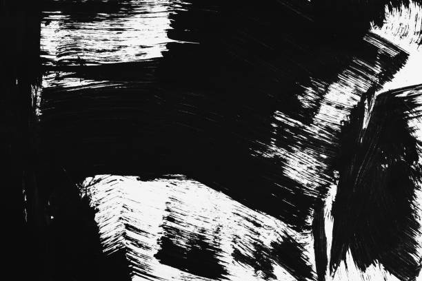 istock Patterns of black paint from a brush on a white background 1202071886