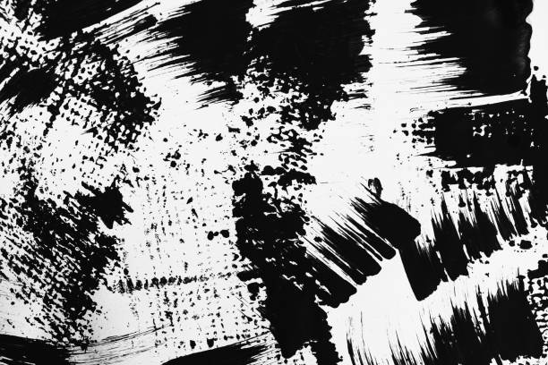 istock Patterns of black paint from a brush on a white background 1202072039
