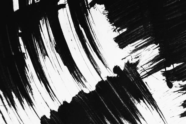 istock Patterns of black paint from a brush on a white background 1202072113