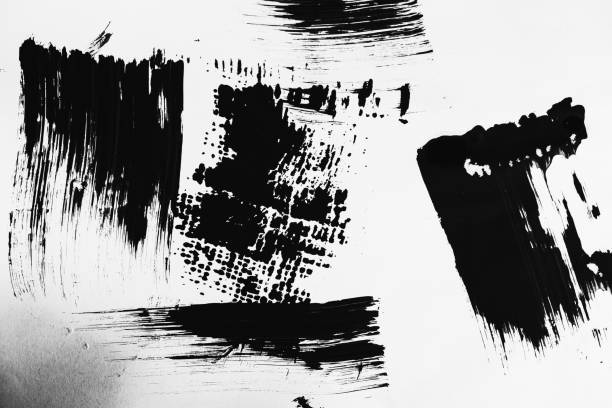 istock Patterns of black paint from a brush on a white background 1202072173