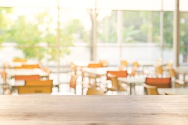 istock empty wood table with blurred food restaurant table 1202072198