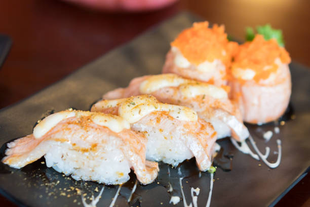 istock fresh salmon sushi on black japanese plate 1202072221