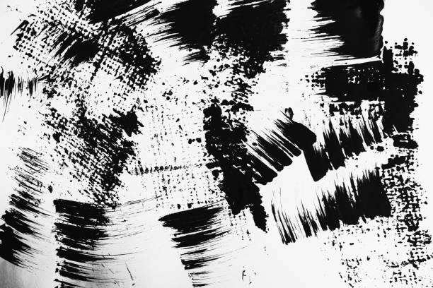 istock Patterns of black paint from a brush on a white background 1202072944