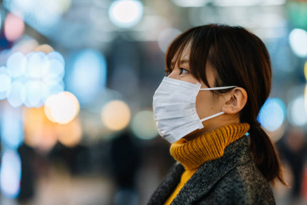 portrait of young woman wearing face mask - bg imagens e fotografias de stock