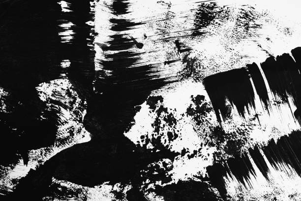 istock Patterns of black paint from a brush on a white background 1202072971