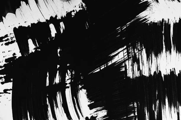 istock Patterns of black paint from a brush on a white background 1202073011