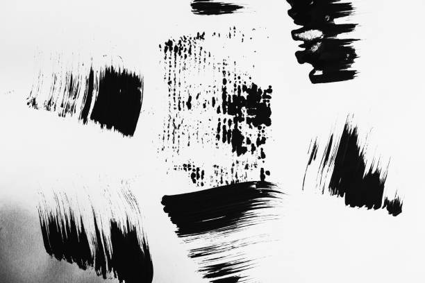 istock Patterns of black paint from a brush on a white background 1202073030
