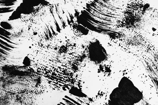 istock Patterns of black paint from a brush on a white background 1202073152
