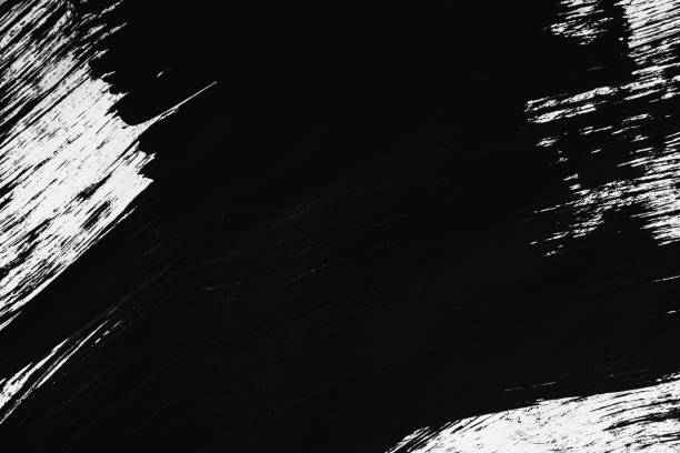 istock Patterns of black paint from a brush on a white background 1202073163