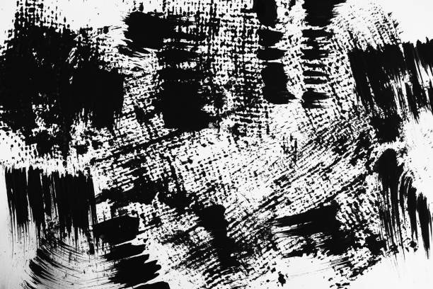 istock Patterns of black paint from a brush on a white background 1202073248