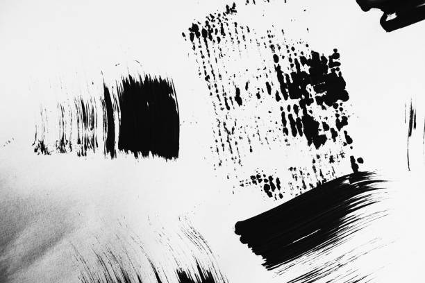 istock Patterns of black paint from a brush on a white background 1202073255