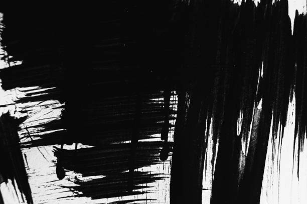 istock Patterns of black paint from a brush on a white background 1202073365