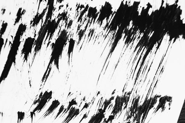 istock Patterns of black paint from a brush on a white background 1202073382