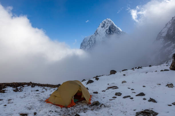 istock Camping tent in snowy mountains. 1202073955