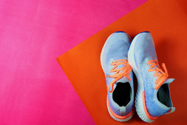 istock sneaker or running shoes on pink and orange floor with copy text space,top view 1202074358