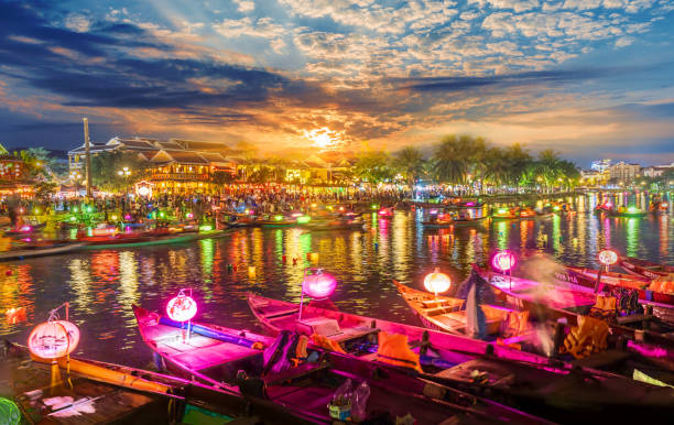 Landscape with wooden boats and lanterns Landscape with wooden boats and lanterns on Thu Bon River at sunset in Hoi An , Vietnam hoi an stock pictures, royalty-free photos & images