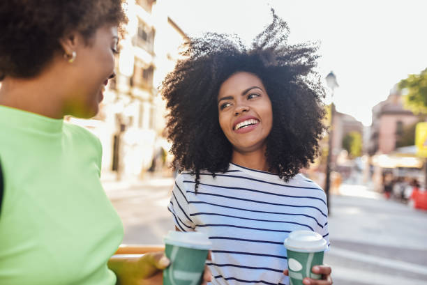 istock Girls drinking coffee and having fun outdoors 1202079779