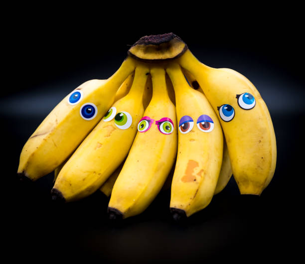 istock Group or bunch of mini bananas with anthropomorphic faces 1202080469