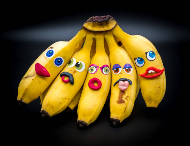 istock Group or bunch of mini bananas with anthropomorphic faces 1202080472