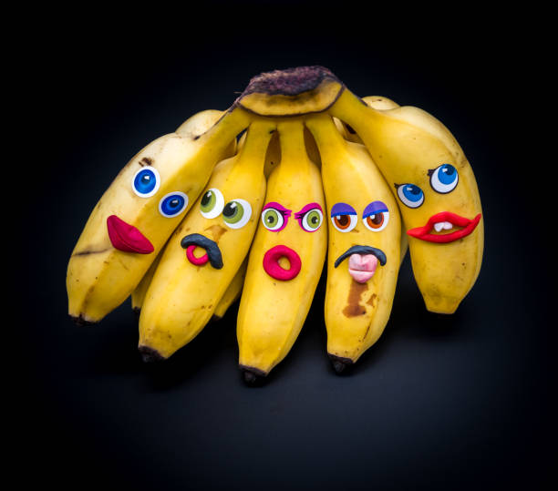 istock Group or bunch of mini bananas with anthropomorphic faces 1202080519