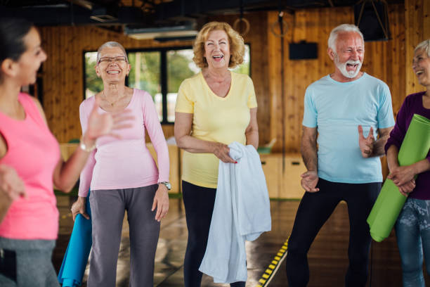 istock Happy seniors starting a group yoga class 1202081906