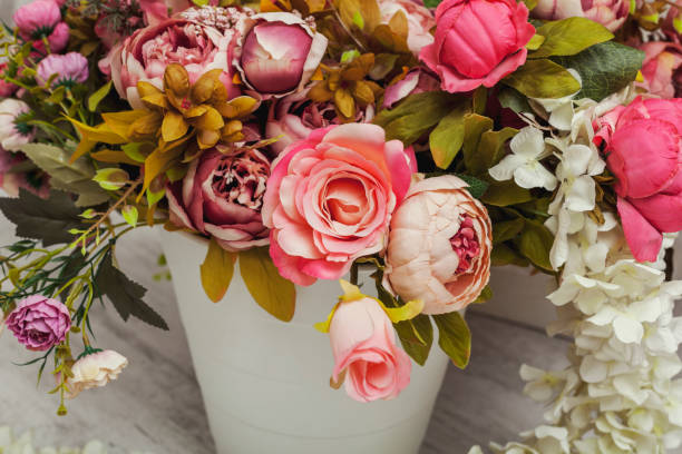 istock Paper and textile artificial flowers in a decorative bouquet. 1202082900