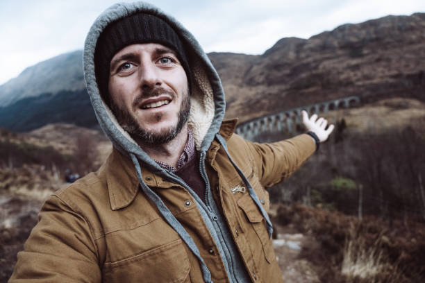 istock man take a selfie in scotland 1202085151
