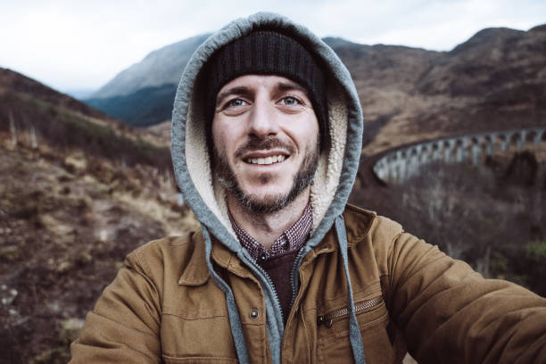 istock man take a selfie in scotland 1202085219
