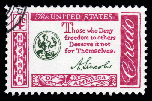 USA vintage Credo postage stamp with Abraham Lincoln's famous quote 'those who deny freedom to others deserve it not for themselves'