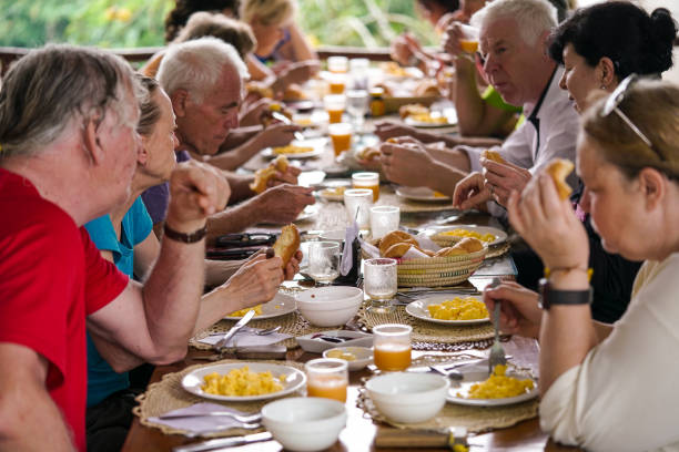 istock Tourists having breakfast at one table at hostel in Misahualli, Ecuador 1202087951